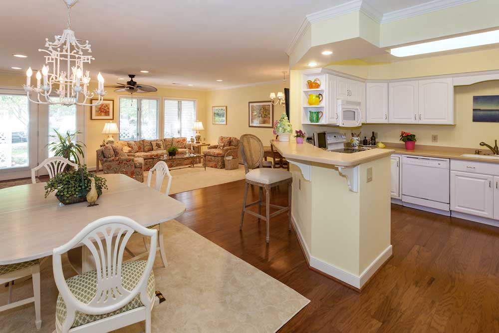 An interior view of a cottage kitchen and great room