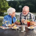 A couple dines on the lakefront grille patio