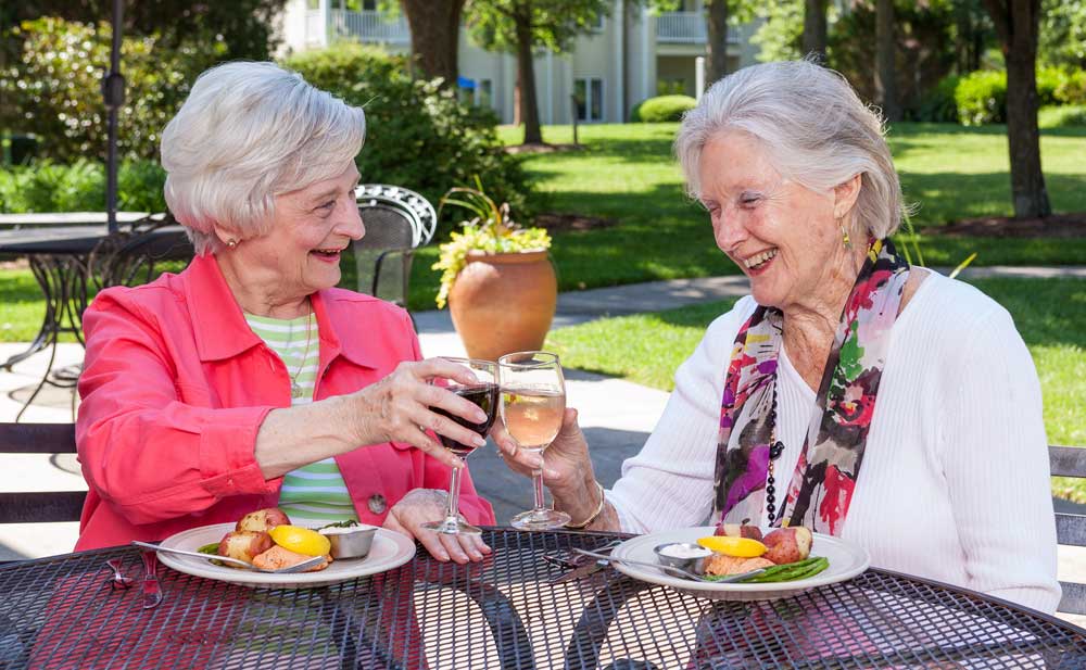 Two women enjoy fine dining on the outdoor patio at the Lakeside Grille