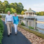 A couple enjoys walking at the lakefront