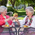 Two ladies enjoy lunch on the patio