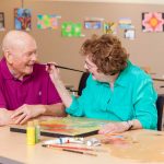 A playful couple enjoys painting