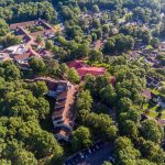 An overhead drone photo of our campus and lake