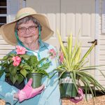A woman enjoys working in our community garden