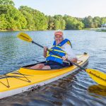 A woman enjoys kayaking on the lake