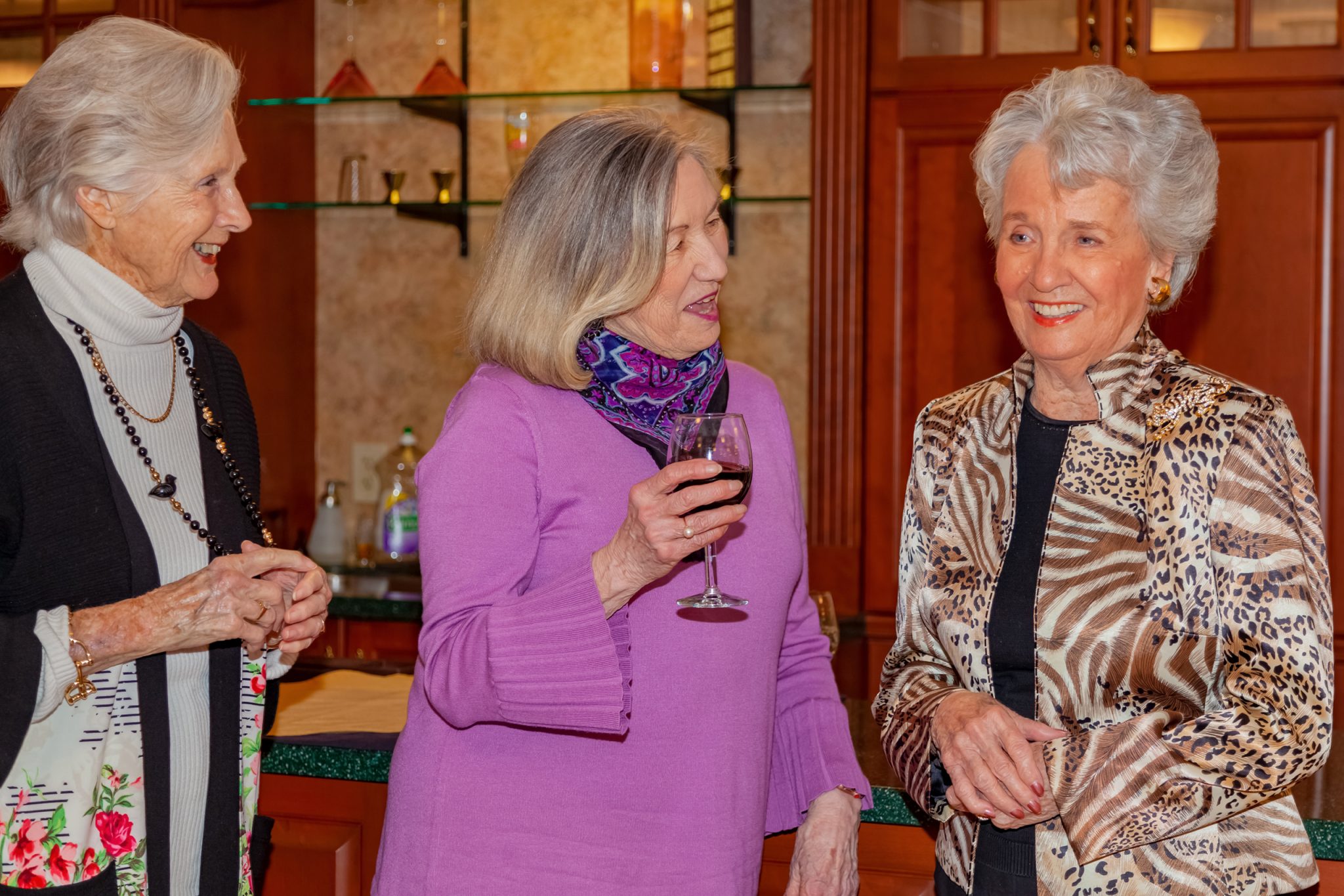 Three ladies enjoy cocktails and conversation at the pub