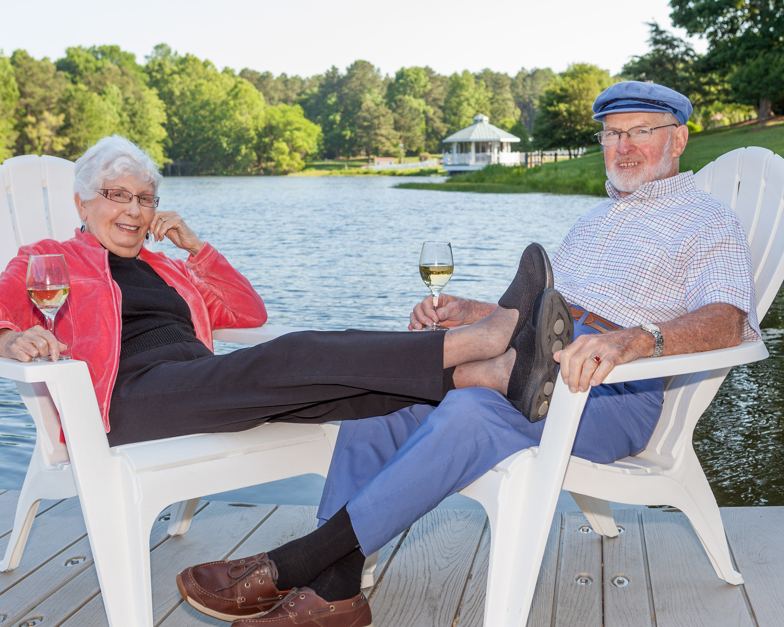 Judge Hess and a lady friend enjoy some wine while sitting on the dock at the lake