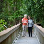 Couple walking across wooden bridge