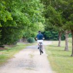 man riding bike on trail