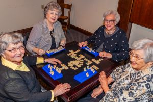 group of women playing Scrabble