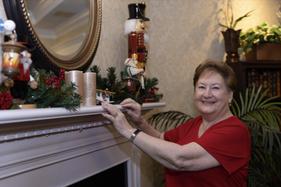 Woman standing at a festival holiday mantel