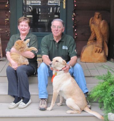 Mary and Brian with their cat and dog outside