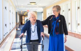 2 women walking down hall