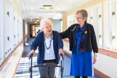 2 women walking down hall