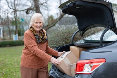 Senior woman packing her car