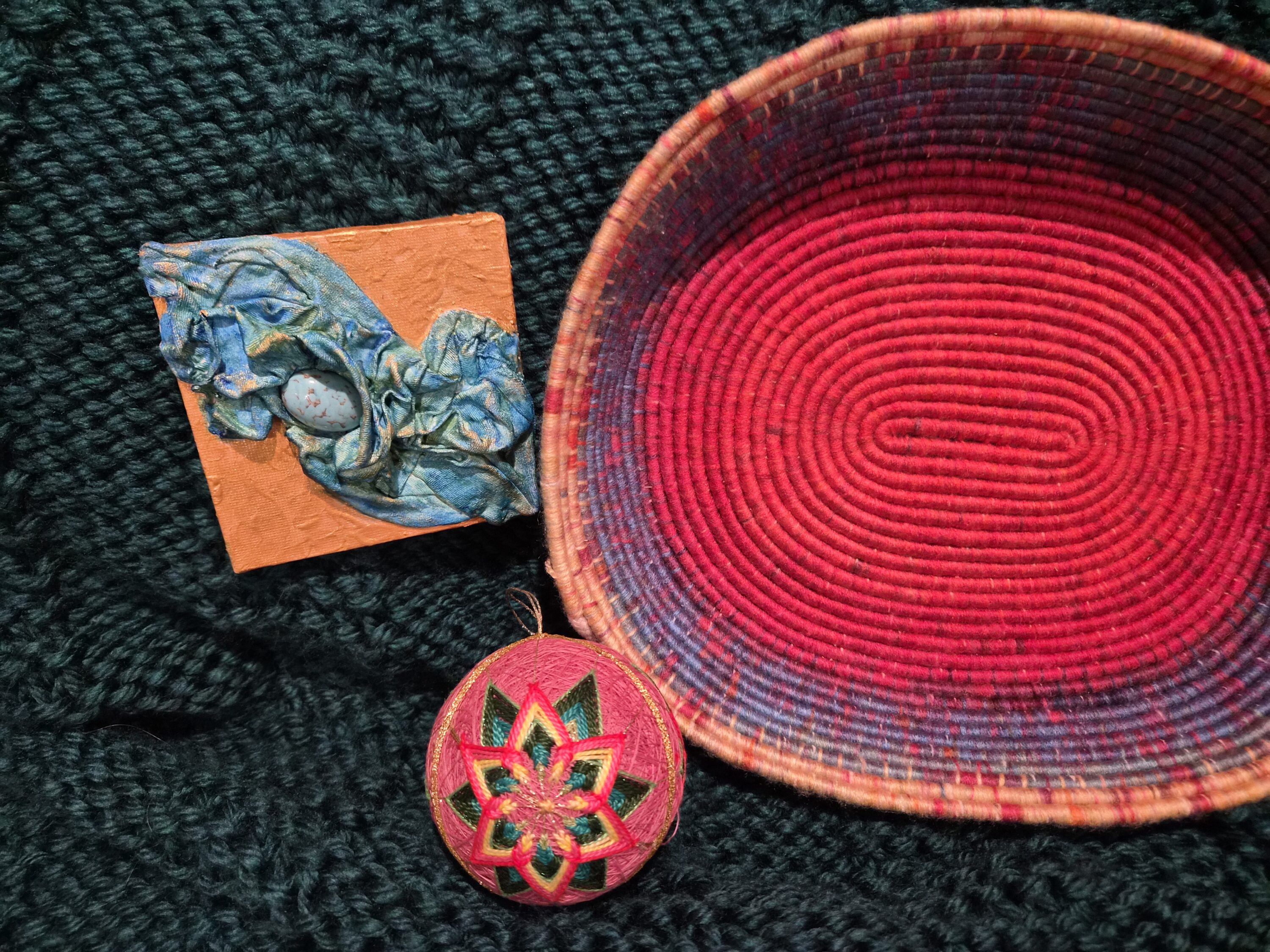 Colorful textile ribbons, bead, and embroidered thread ornament