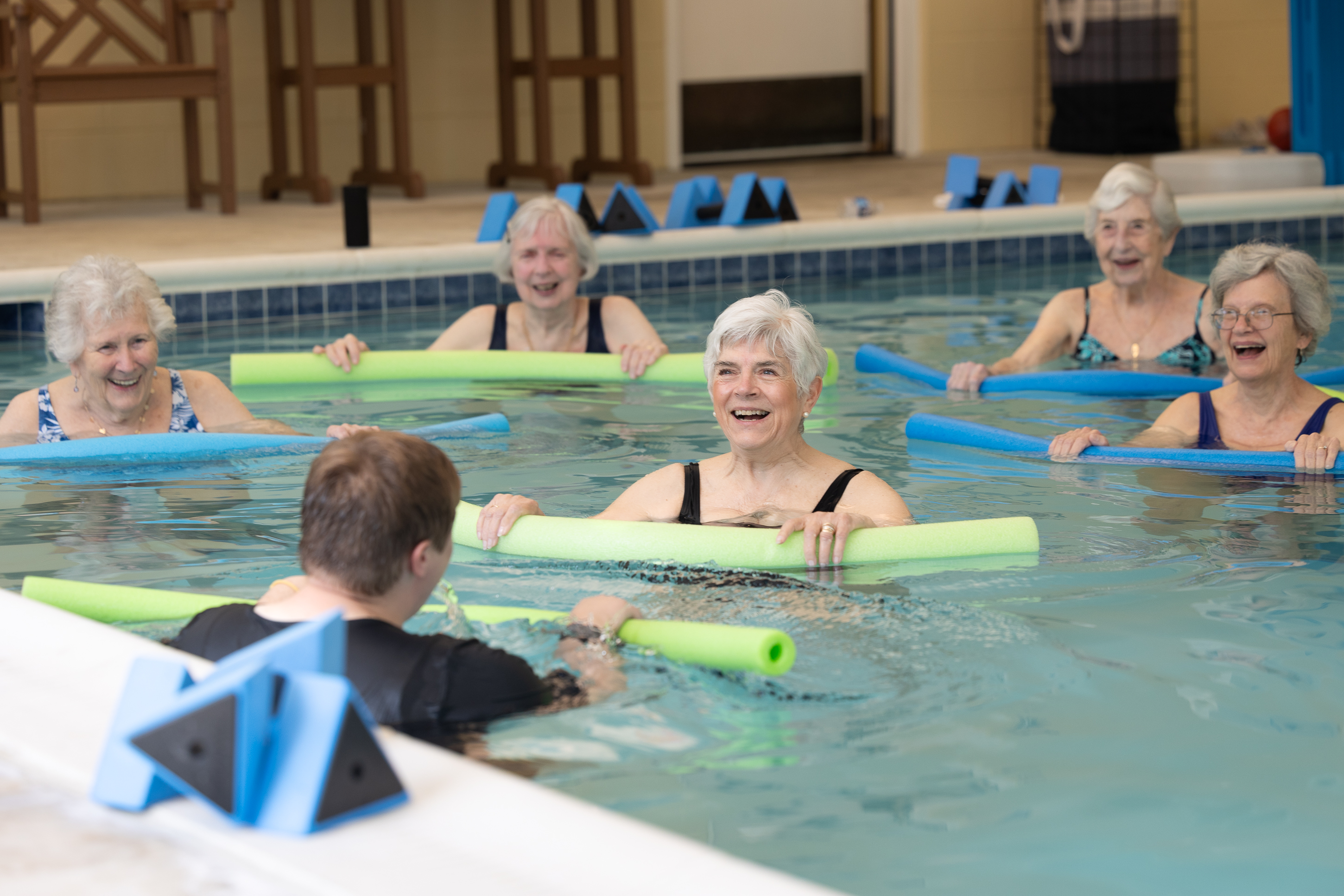 Senior women enjoying water aerobics in indoor pool