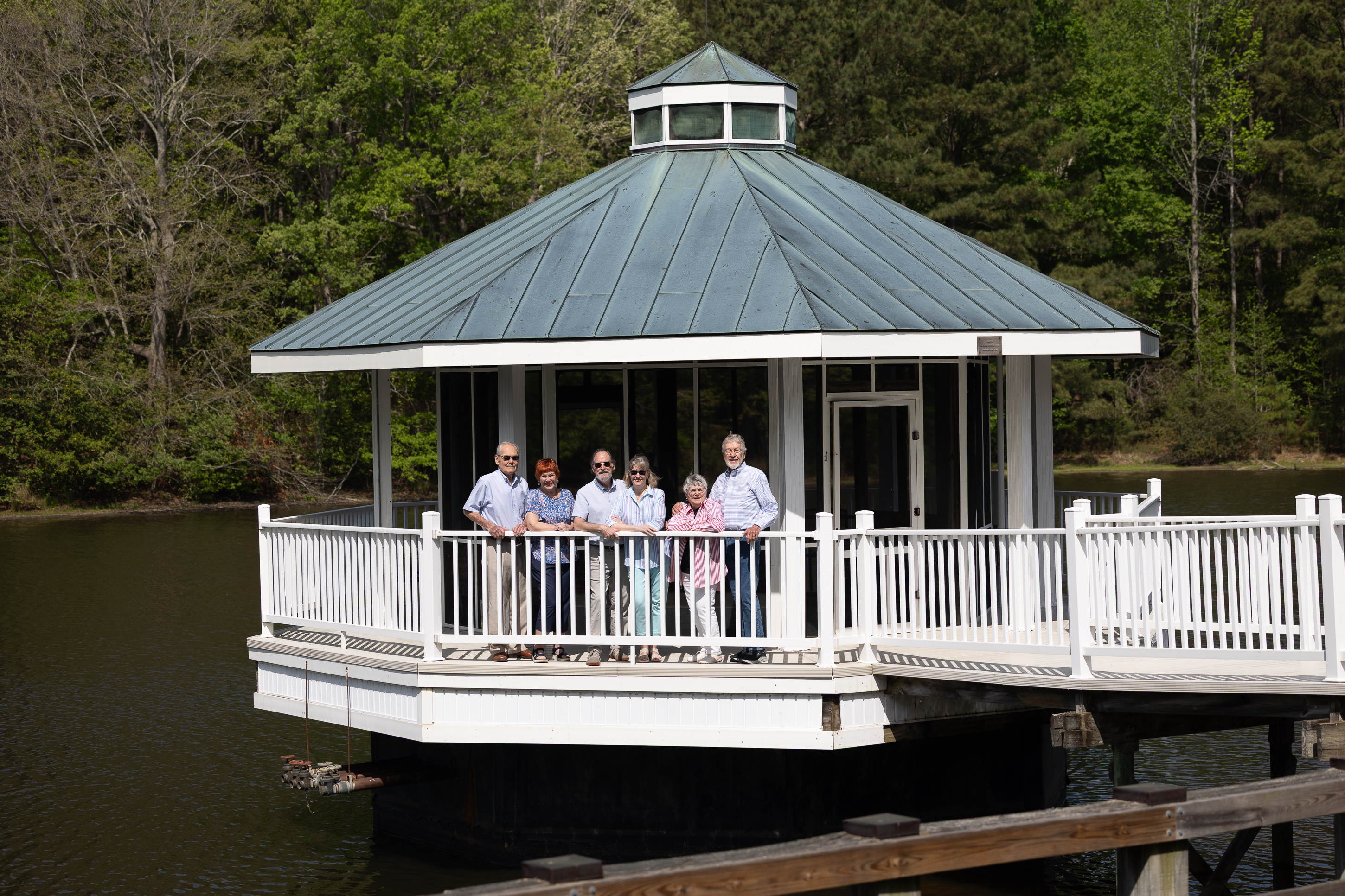 Group of seniors on lakeside gazebo deck