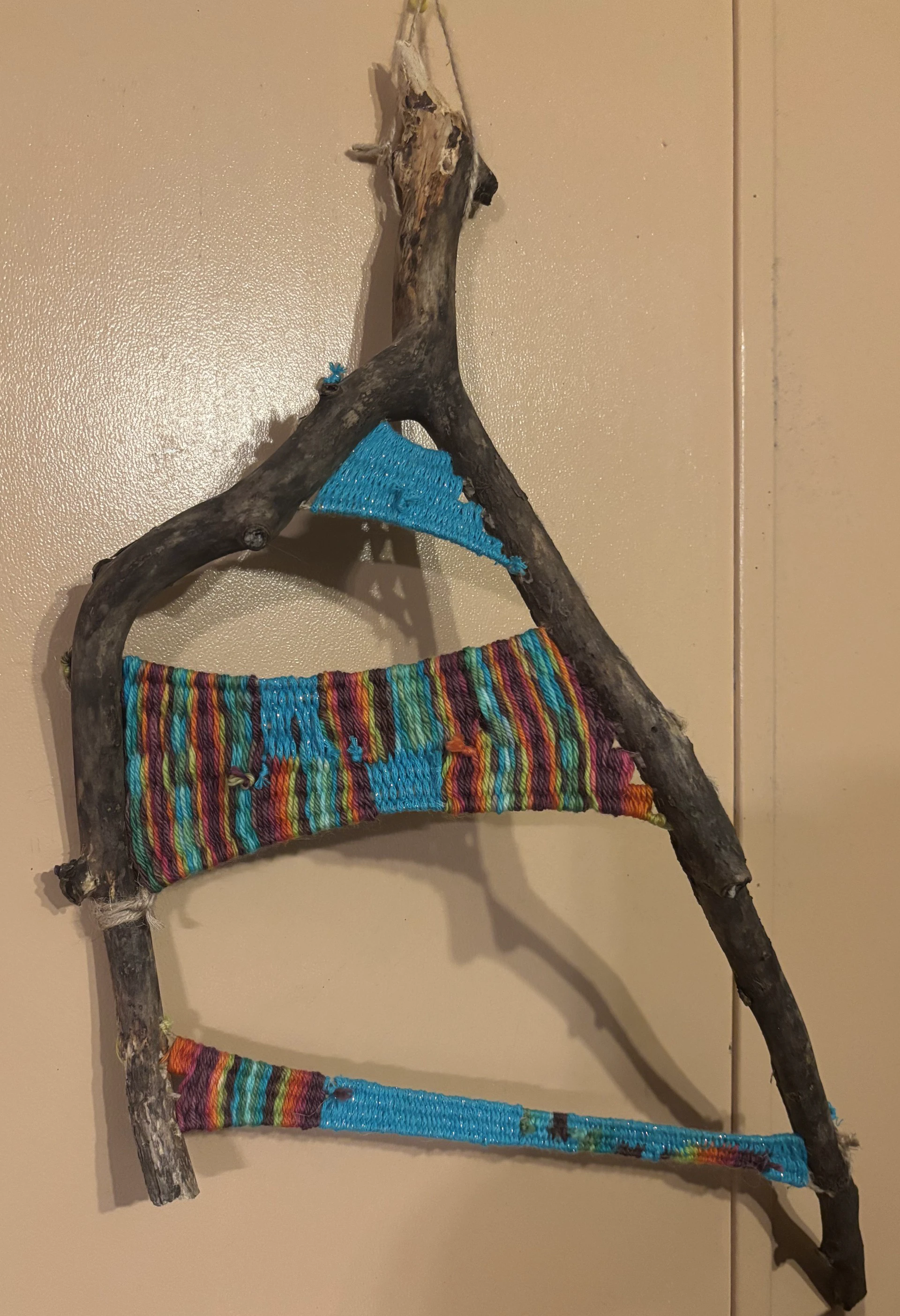 Rustic branch wall hanging with colorful yarn weaving