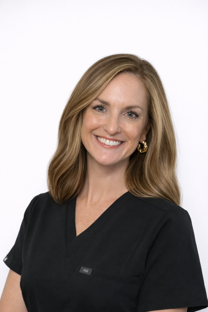 Smiling woman in black medical scrubs headshot