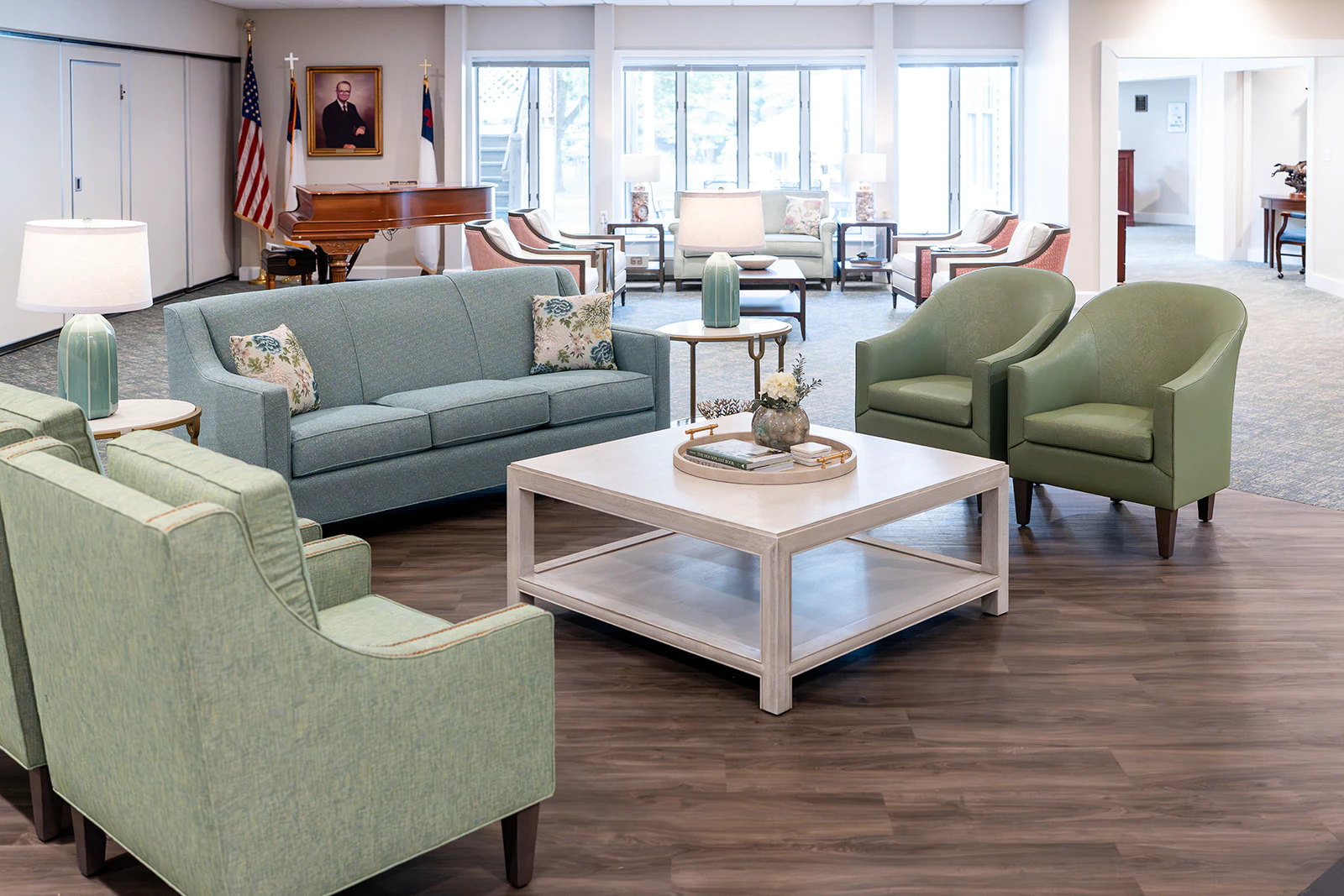 Bright church lounge with sofas, chairs, and piano