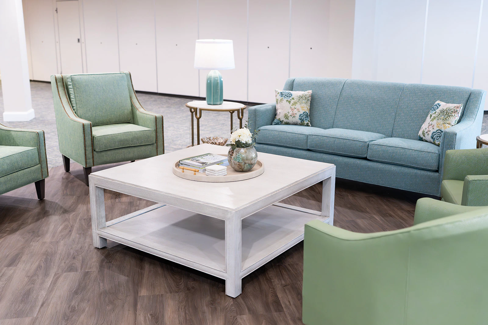 Modern living room with teal sofa and armchairs