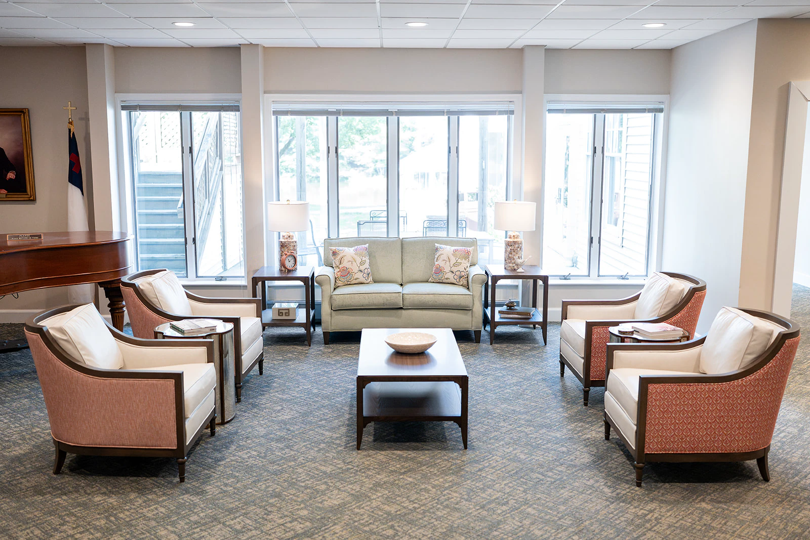 Bright lounge with sofa and armchairs by windows