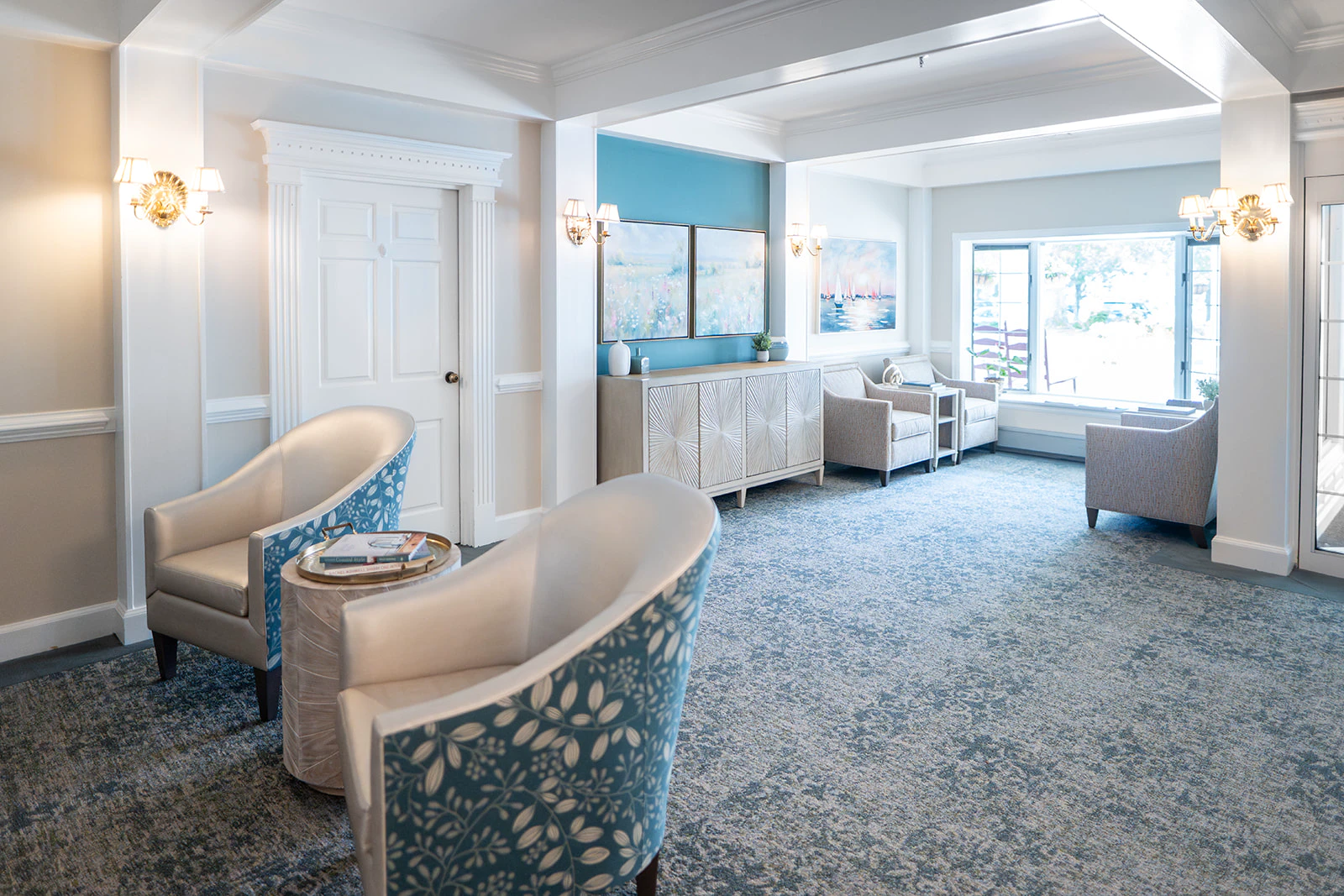 Elegant lounge area with blue chairs and large window