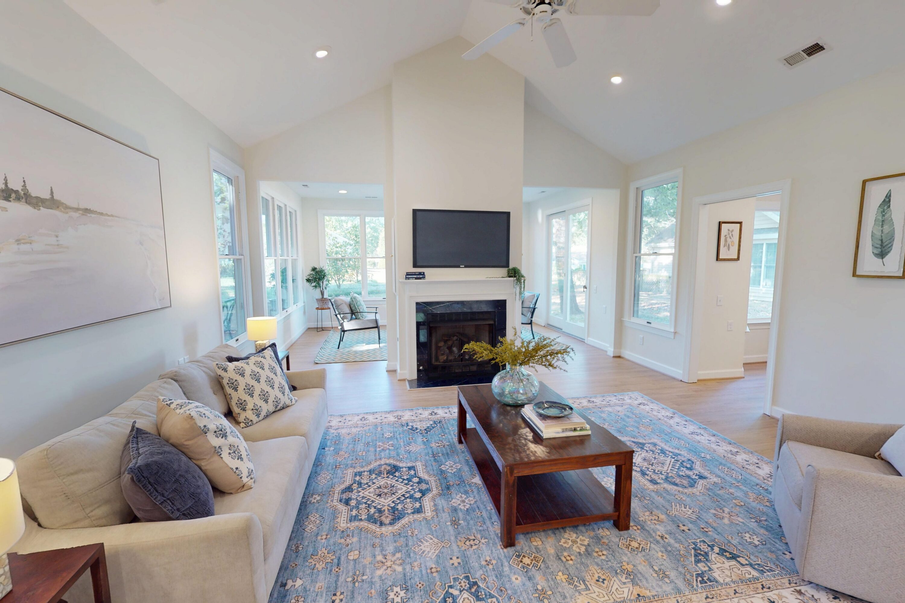 Bright living room with fireplace and blue rug
