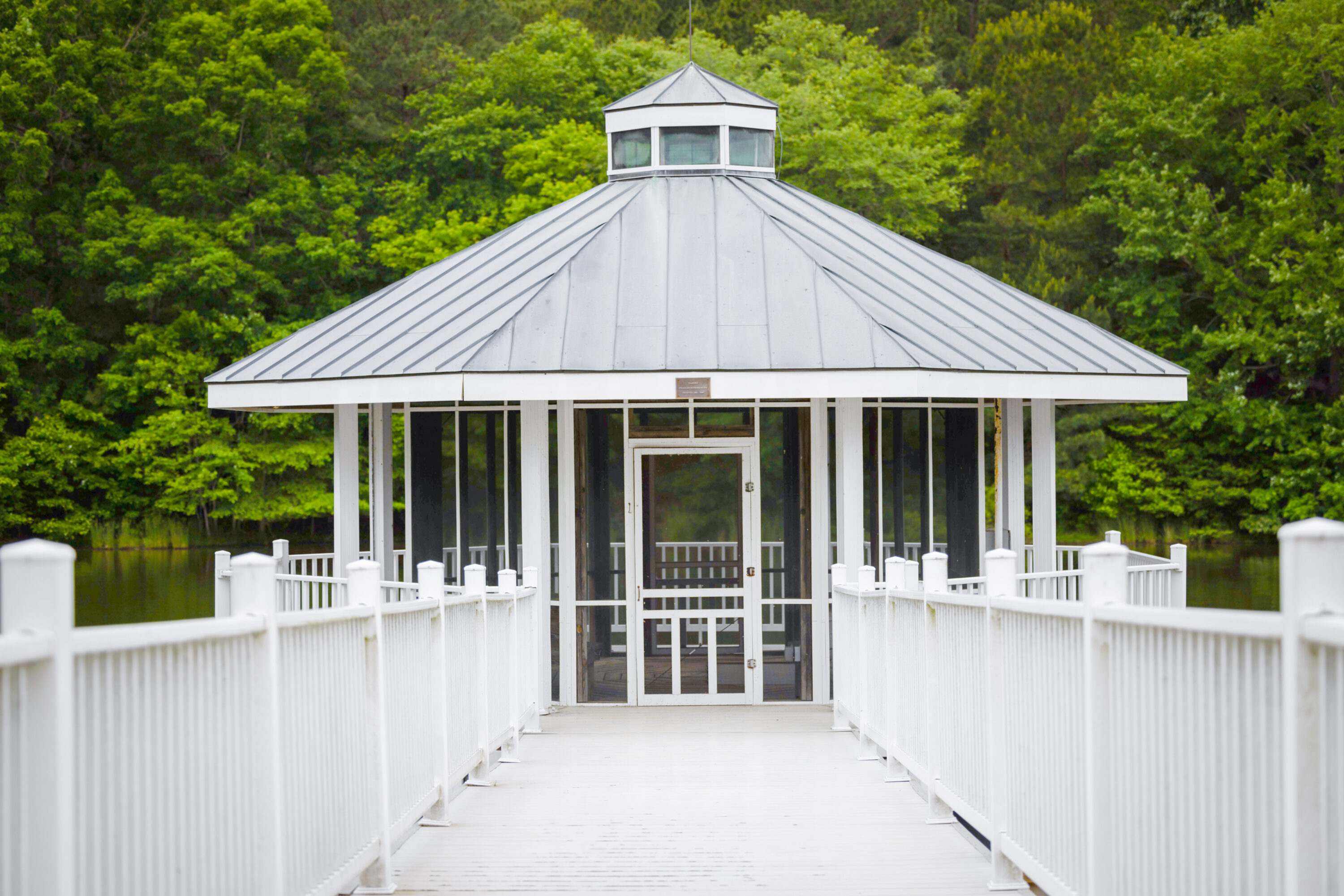 White gazebo at end of lakeside pier