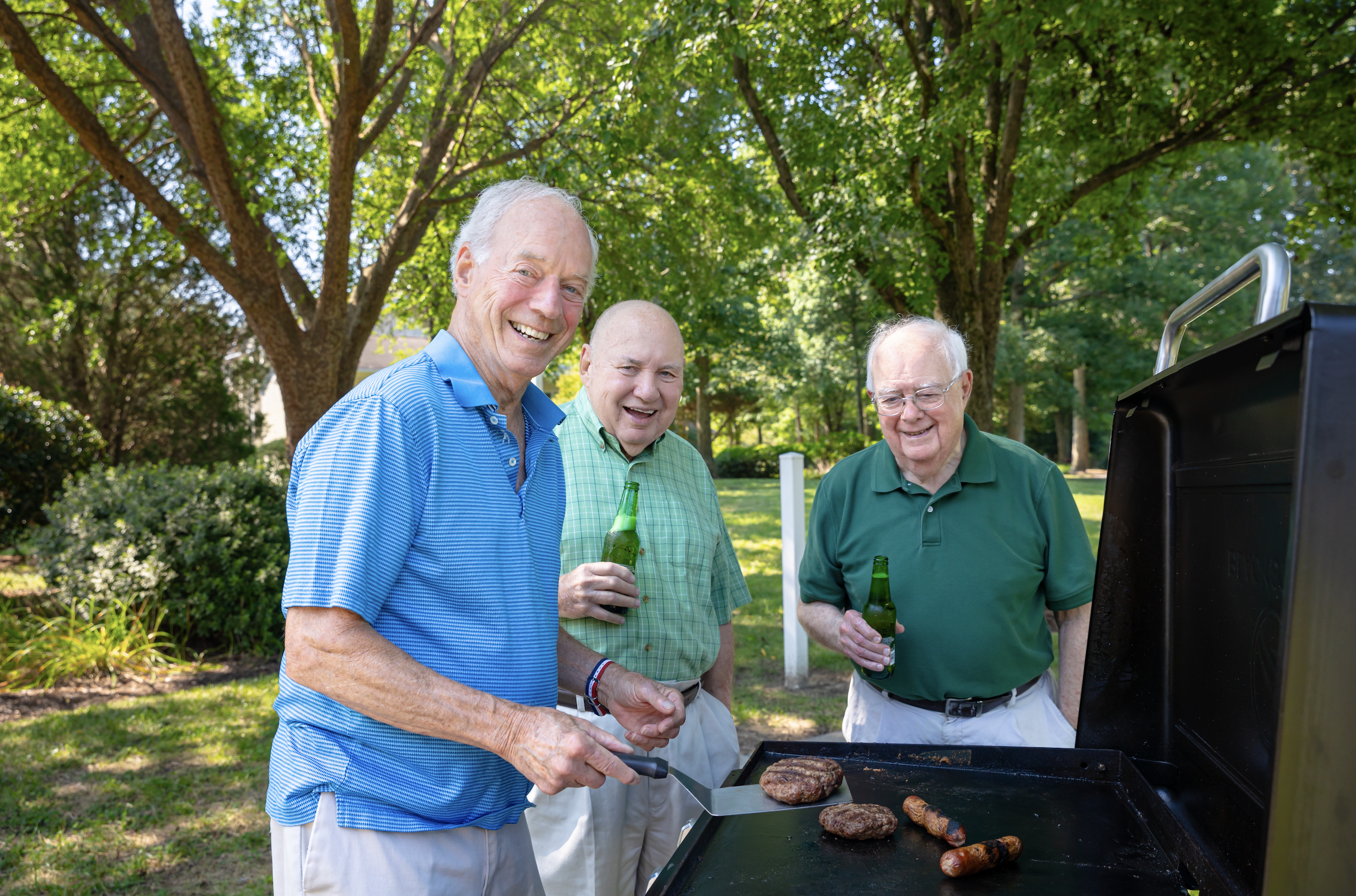 3 senior men grilling