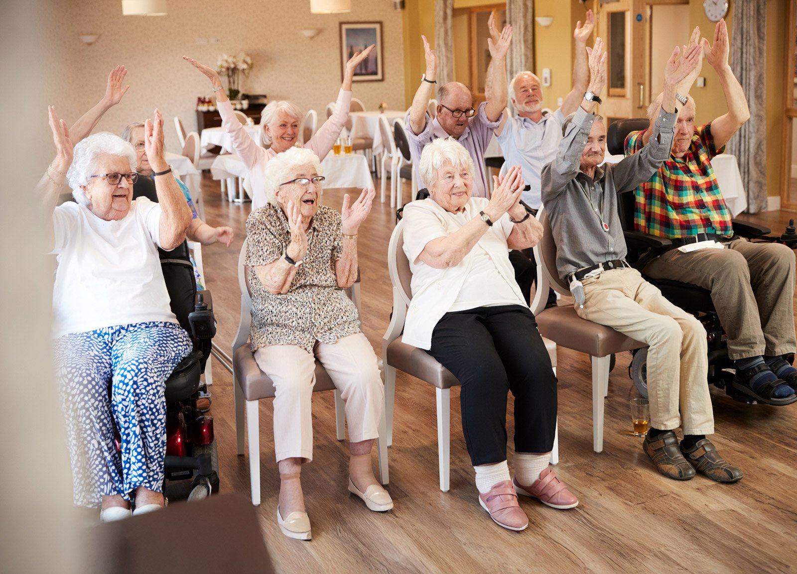 Seniors raising hands during group exercise class