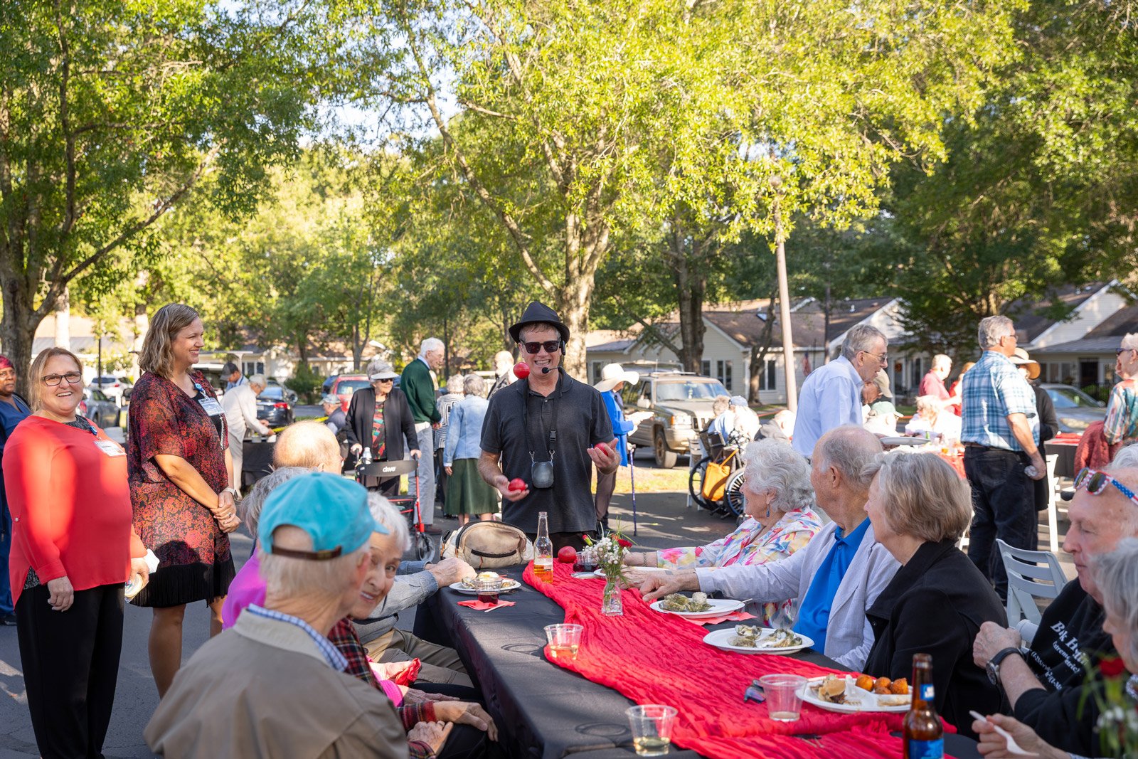 Entertainer juggling apples at outdoor senior gathering