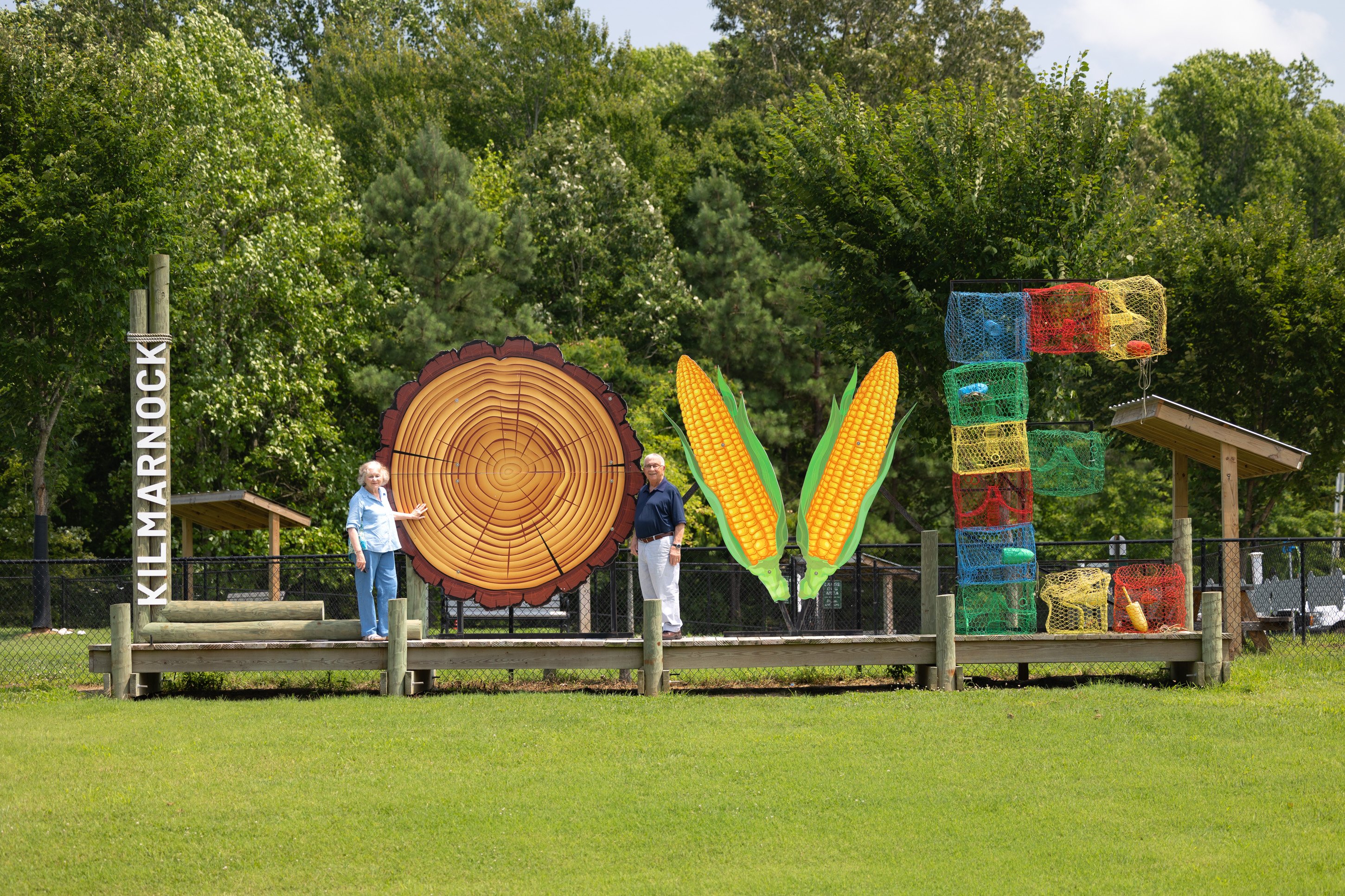Couple beside large outdoor sculptures in park