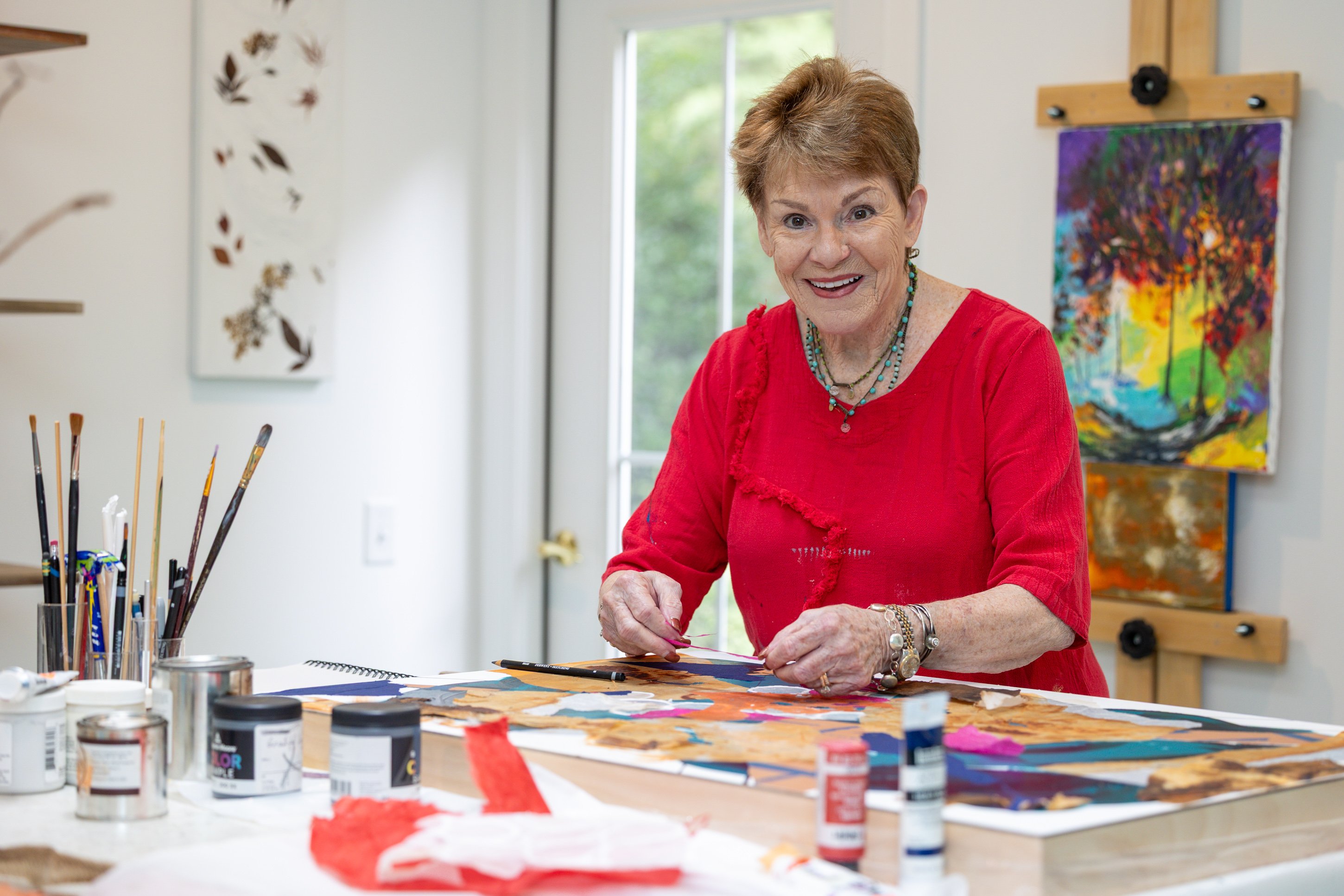 Smiling woman creating art in bright studio