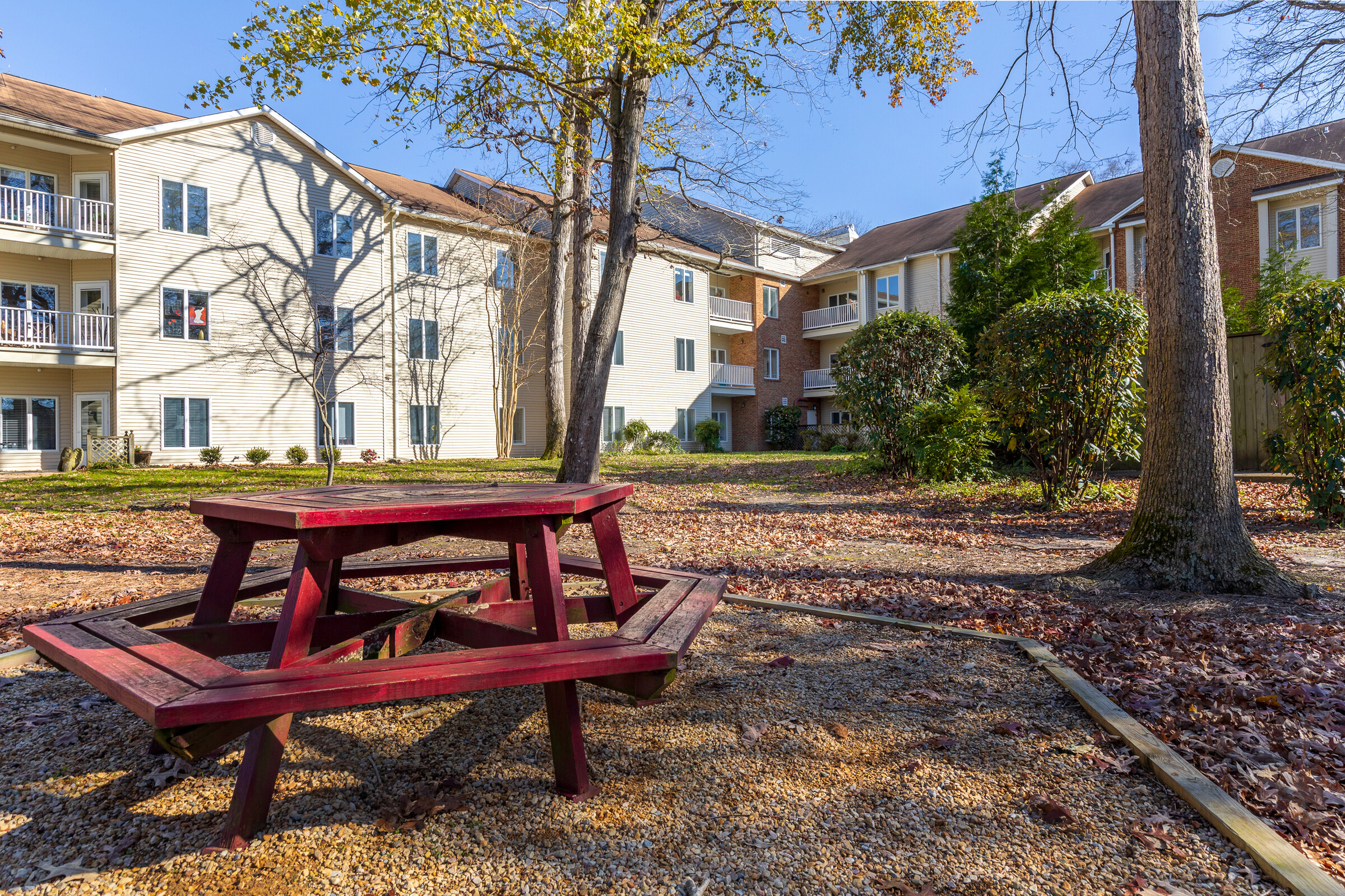 Apartment courtyard with red picnic table and balconies